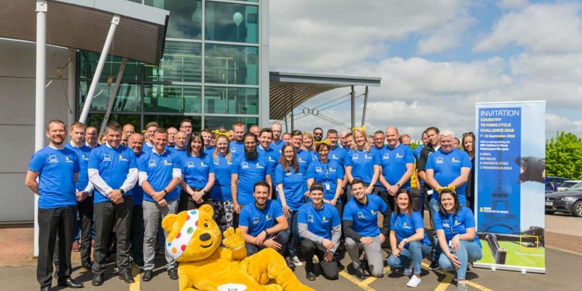 gefco covtoparis Group shot of people taking part in charity cycle ride for Children in Need with Pudsey Bear