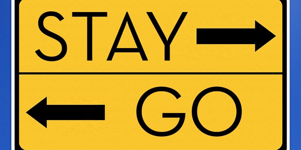 stay or go_sq Road sign with arrow pointing one way to Stay and another way to Go